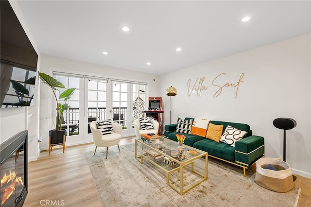 906 N Doheny Dr Unit 318, West Hollywood, CA 90069 - living area featuring wood finished floors, a glass covered fireplace, recessed lighting, and baseboards