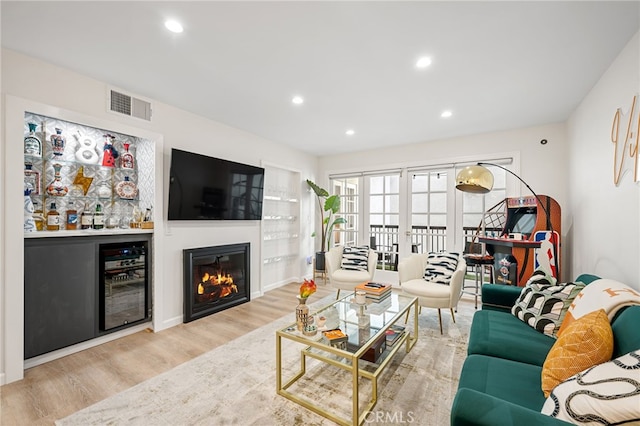 906 N Doheny Dr Unit 318, West Hollywood, CA 90069 - living room with wine cooler, wood finished floors, recessed lighting, and a glass covered fireplace