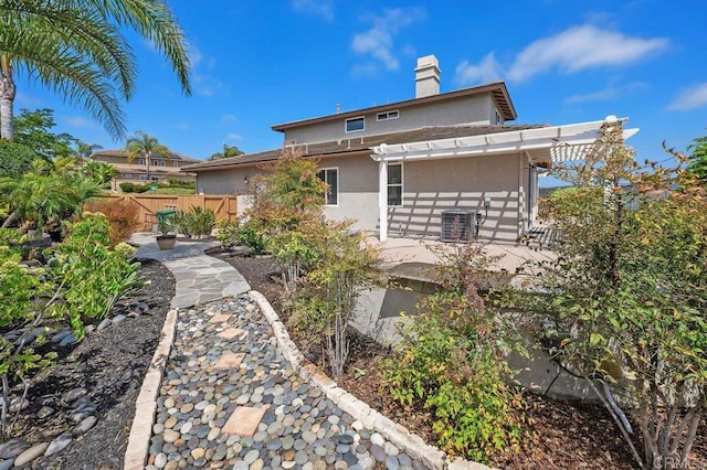 4729 Crater Rim Rd, Carlsbad, CA 92010 - back of property featuring a fenced backyard, a chimney, stucco siding, a pergola, and a patio