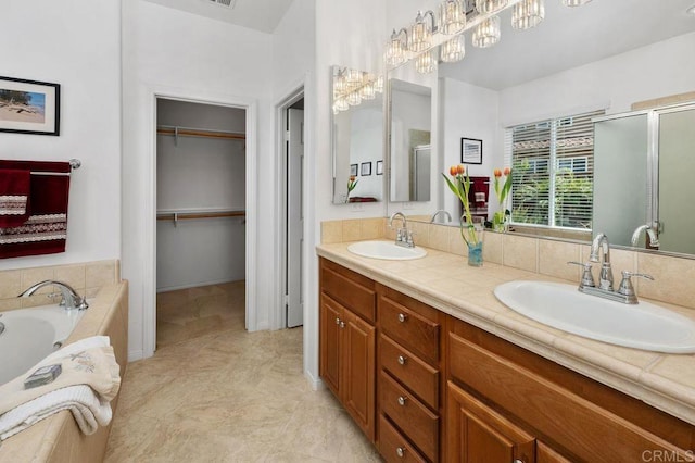 4729 Crater Rim Rd, Carlsbad, CA 92010 - bathroom featuring a stall shower, double vanity, a spacious closet, and a garden tub