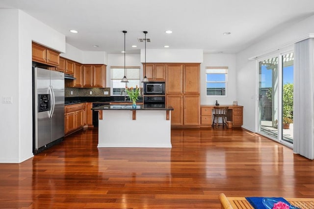 4729 Crater Rim Rd, Carlsbad, CA 92010 - kitchen with black appliances, brown cabinetry, dark countertops, dark wood finished floors, and recessed lighting