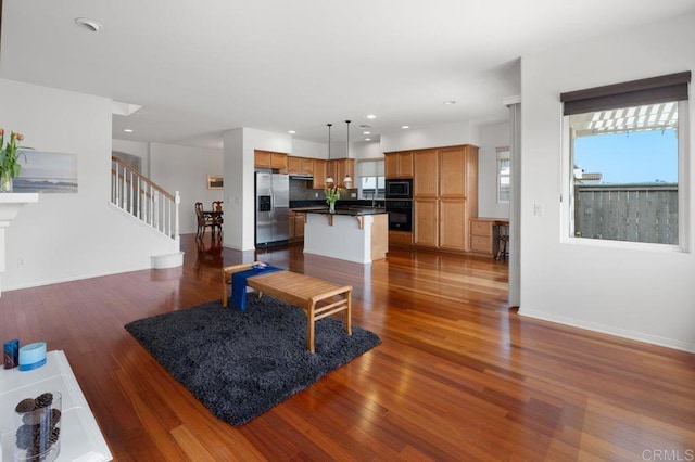4729 Crater Rim Rd, Carlsbad, CA 92010 - living area with healthy amount of natural light, dark wood-type flooring, stairs, recessed lighting, and baseboards