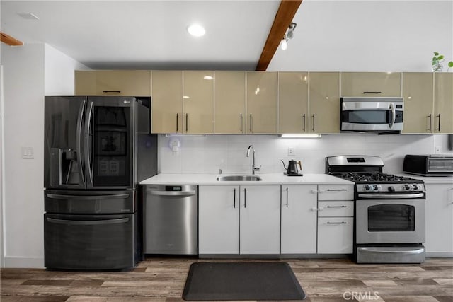 4215 Glencoe Ave Unit 103, Marina Del Rey, CA 90292 - kitchen featuring stainless steel appliances, a sink, light countertops, decorative backsplash, and beam ceiling