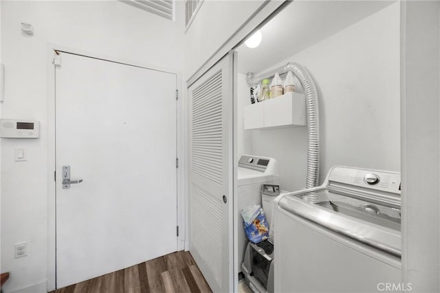 4215 Glencoe Ave Unit 103, Marina Del Rey, CA 90292 - washroom with washing machine and dryer, dark wood-style flooring, and cabinet space