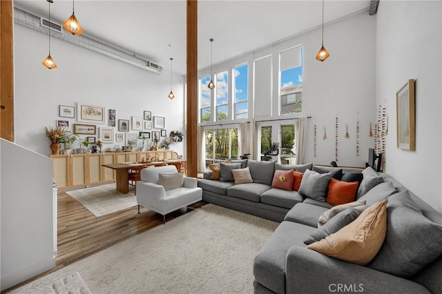4215 Glencoe Ave Unit 103, Marina Del Rey, CA 90292 - living room featuring a towering ceiling and wood finished floors