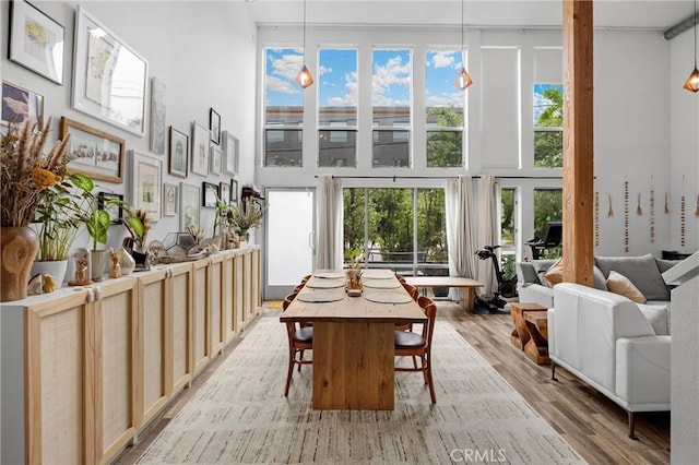 4215 Glencoe Ave Unit 103, Marina Del Rey, CA 90292 - dining area with a high ceiling, light wood-style flooring, and plenty of natural light