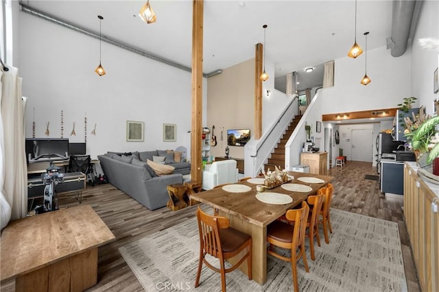 4215 Glencoe Ave Unit 103, Marina Del Rey, CA 90292 - dining space featuring a high ceiling, wood finished floors, and stairway