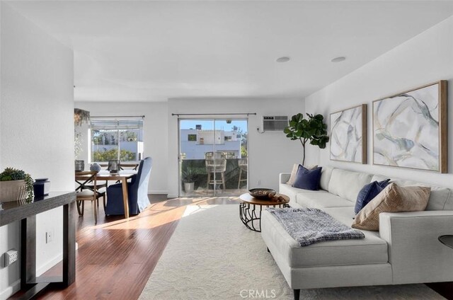 1914 Corinth Ave Unit 201, Los Angeles, CA 90025 - living room with wood finished floors and a wall mounted air conditioner