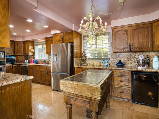 30040 Grandpoint Ln, Rancho Palos Verdes, CA 90275 - kitchen featuring appliances with stainless steel finishes, beverage cooler, tasteful backsplash, a chandelier, and brown cabinetry