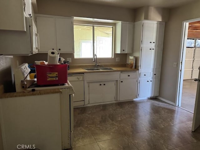 1447 W Westward Ave, Banning, CA 92220 - kitchen featuring dishwasher, a sink, white cabinetry, light countertops, and baseboards