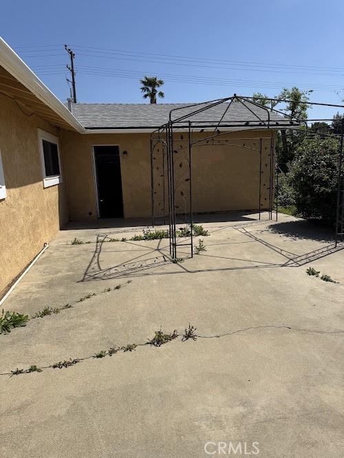 1447 W Westward Ave, Banning, CA 92220 - view of patio with a garage and driveway