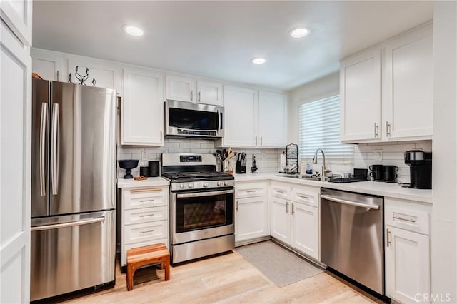23502 Cambridge Rd Unit 306, Yorba Linda, CA 92887 - kitchen with appliances with stainless steel finishes, a sink, backsplash, white cabinetry, and recessed lighting