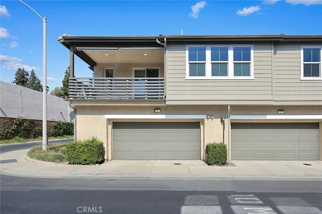 2333 S Via Esplanade Unit 25, Ontario, CA 91762 - back of house featuring a balcony, stucco siding, and a garage
