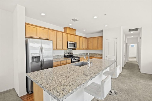 2333 S Via Esplanade Unit 25, Ontario, CA 91762 - kitchen with appliances with stainless steel finishes, a sink, recessed lighting, a center island with sink, and light colored carpet