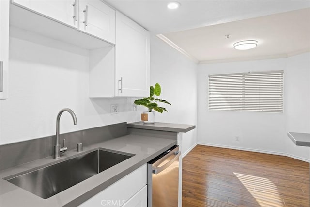 4511 Murietta Ave Unit 8, Sherman Oaks, CA 91423 - kitchen featuring a sink, dishwasher, wood finished floors, white cabinetry, and baseboards