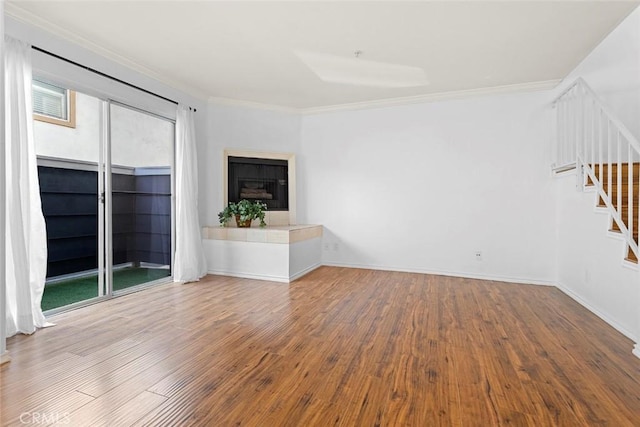 4511 Murietta Ave Unit 8, Sherman Oaks, CA 91423 - unfurnished living room with ornamental molding, stairs, wood finished floors, baseboards, and a fireplace with raised hearth