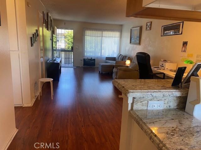 7100 Cerritos Ave Unit 112, Stanton, CA 90680 - living area with dark wood finished floors, baseboards, and an office area