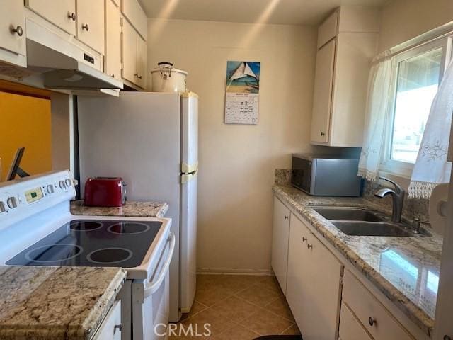 7100 Cerritos Ave Unit 112, Stanton, CA 90680 - kitchen with electric stove, stainless steel microwave, a sink, and white cabinetry