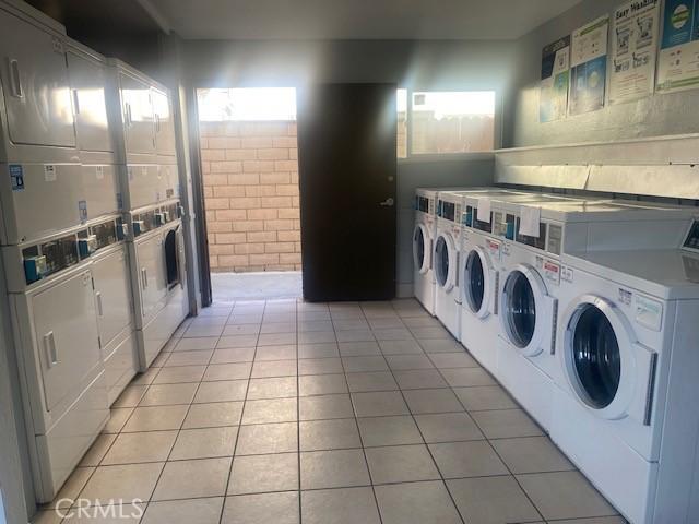 7100 Cerritos Ave Unit 112, Stanton, CA 90680 - shared laundry room featuring stacked washer and clothes dryer, washer and clothes dryer, and light tile patterned floors