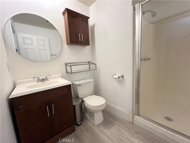 19950 Sherman Way Unit A, Winnetka, CA 91306 - full bath featuring vanity, wood finished floors, a shower stall, toilet, and baseboards