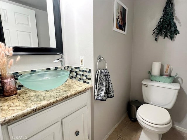 19950 Sherman Way Unit A, Winnetka, CA 91306 - half bath featuring vanity, tile patterned floors, tasteful backsplash, toilet, and baseboards