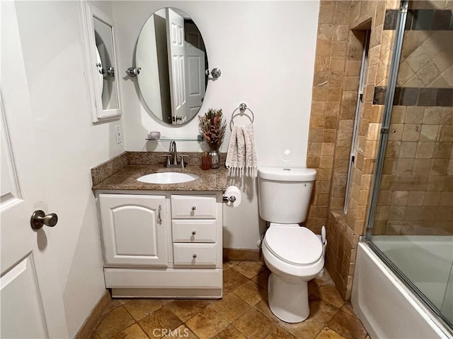 19950 Sherman Way Unit A, Winnetka, CA 91306 - bathroom featuring vanity, toilet, combined bath / shower with glass door, and baseboards