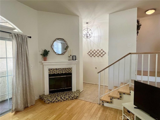 19950 Sherman Way Unit A, Winnetka, CA 91306 - entrance foyer with wood finished floors, a tiled fireplace, and stairs