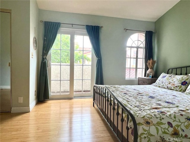 19950 Sherman Way Unit A, Winnetka, CA 91306 - bedroom with light wood-style flooring, access to exterior, and baseboards