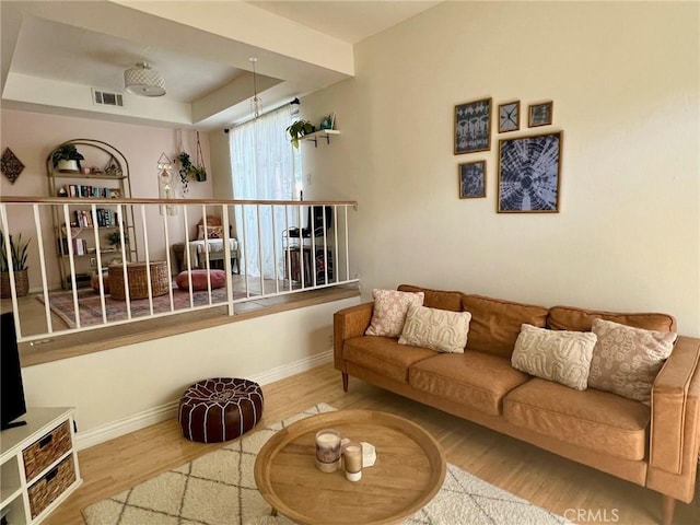 19950 Sherman Way Unit A, Winnetka, CA 91306 - living area with wood finished floors, baseboards, and a tray ceiling