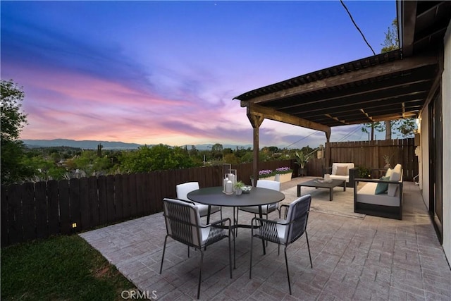 6172 Dalecrest Ave, Woodland Hills, CA 91367 - patio terrace at dusk with a patio area, a fenced backyard, outdoor dining area, and an outdoor hangout area