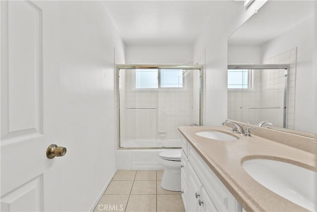 6172 Dalecrest Ave, Woodland Hills, CA 91367 - bathroom featuring tile patterned floors, toilet, double vanity, shower / bath combination with glass door, and baseboards