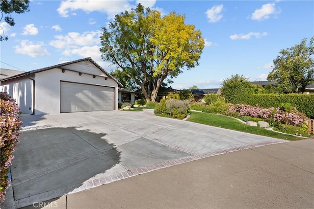 6172 Dalecrest Ave, Woodland Hills, CA 91367 - view of front facade with a garage, driveway, and stucco siding