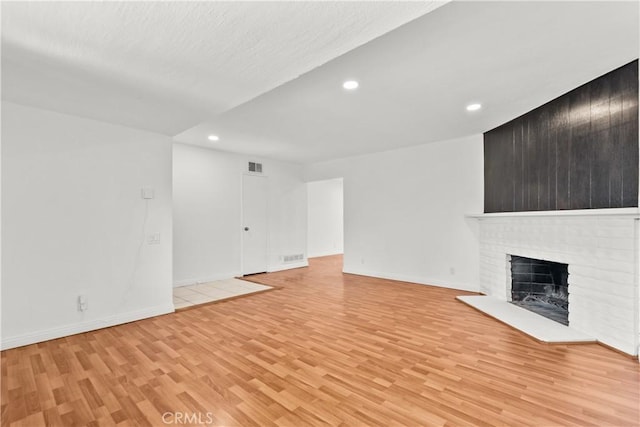6172 Dalecrest Ave, Woodland Hills, CA 91367 - unfurnished living room featuring light wood finished floors, recessed lighting, baseboards, and a brick fireplace