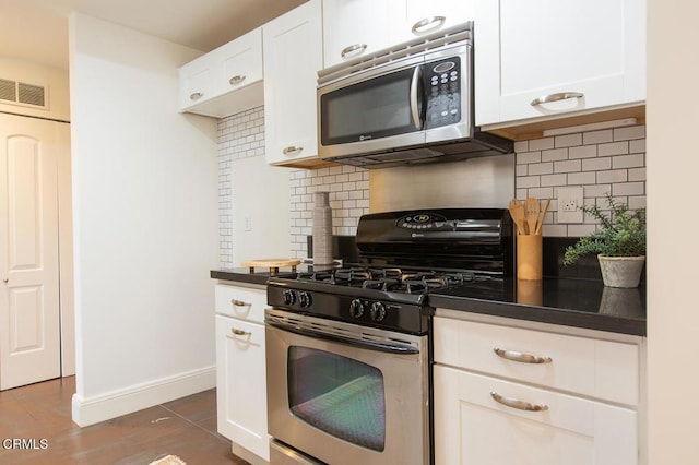 130 S Mentor Ave Unit 205, Pasadena, CA 91106 - kitchen featuring appliances with stainless steel finishes, dark countertops, backsplash, and white cabinetry