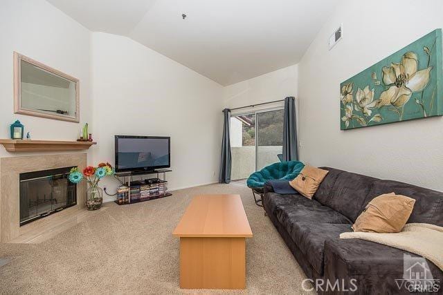 5805 Oak Bend Ln Unit 407, Oak Park, CA 91377 - carpeted living room featuring lofted ceiling and a glass covered fireplace