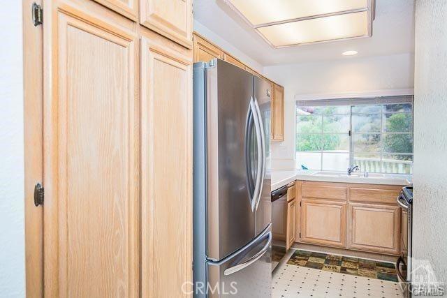 5805 Oak Bend Ln Unit 407, Oak Park, CA 91377 - kitchen featuring stainless steel appliances, light brown cabinets, light countertops, and a sink