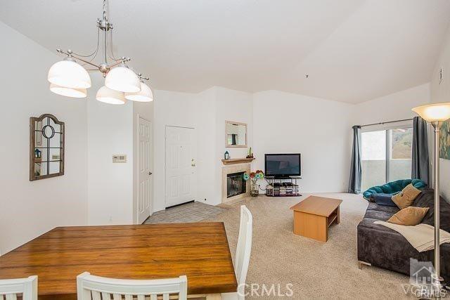 5805 Oak Bend Ln Unit 407, Oak Park, CA 91377 - carpeted dining room featuring a glass covered fireplace and a chandelier