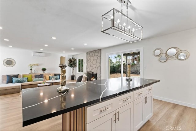 17924 E Kelby St, Covina, CA 91722 - kitchen featuring a wall unit AC, open floor plan, light wood finished floors, dark countertops, and recessed lighting