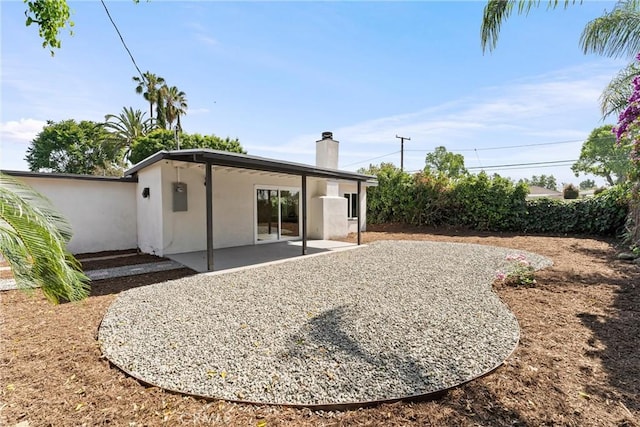 17924 E Kelby St, Covina, CA 91722 - rear view of house with a chimney, stucco siding, and a patio area