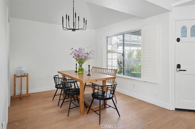 24148 Saint Moritz Dr, Valencia, CA 91355 - dining area featuring light wood finished floors, baseboards, and a chandelier
