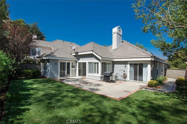 24148 Saint Moritz Dr, Valencia, CA 91355 - back of property featuring a chimney, a patio area, and a tiled roof