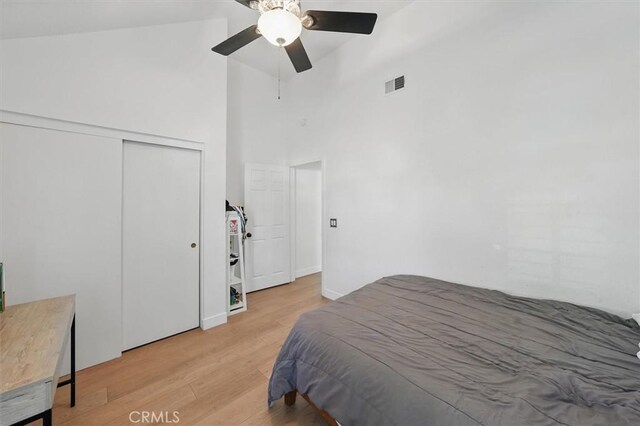 24148 Saint Moritz Dr, Valencia, CA 91355 - bedroom featuring light wood-style flooring, a towering ceiling, a closet, and a ceiling fan