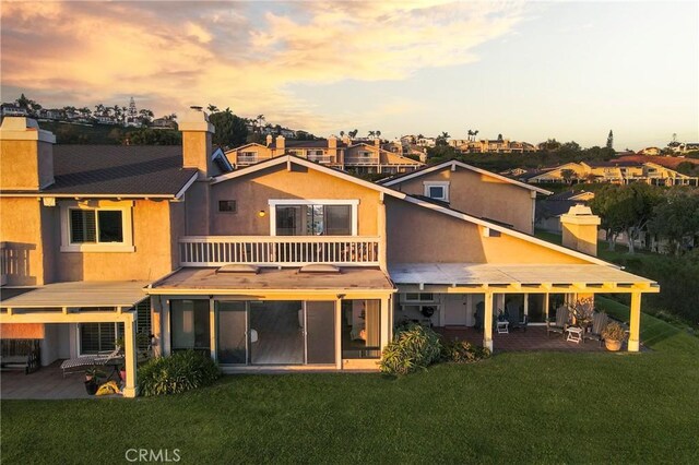 319 Calle Cuervo, San Clemente, CA 92672 - rear view of house with a balcony, a patio area, and a yard