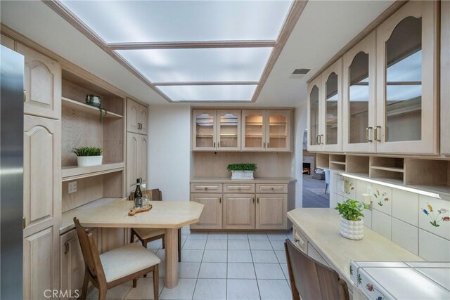 319 Calle Cuervo, San Clemente, CA 92672 - kitchen with open shelves, light countertops, glass insert cabinets, light tile patterned floors, and stainless steel fridge