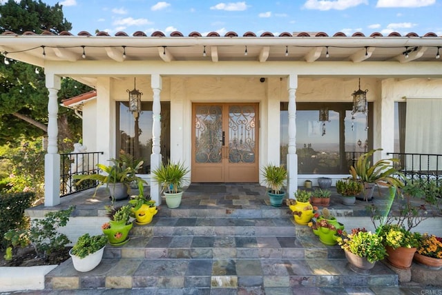 10310 Fuerte Dr, La Mesa, CA 91941 - doorway to property featuring covered porch, stucco siding, and a tiled roof