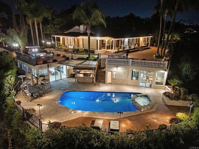 10310 Fuerte Dr, La Mesa, CA 91941 - pool at night featuring stairs, a pool with connected hot tub, and a patio area