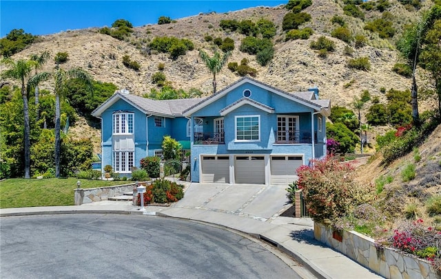 2934 Remy, Burbank, CA 91504 - view of front of home featuring driveway, an attached garage, a mountain view, and stucco siding