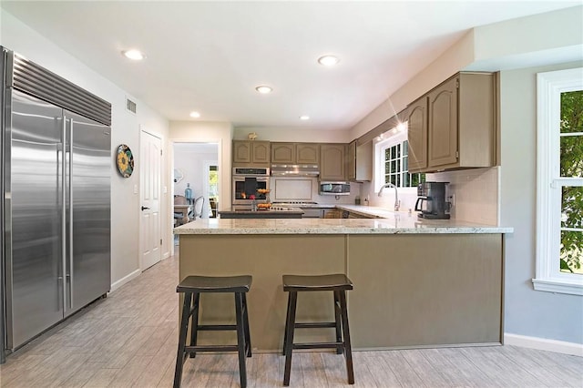 2934 Remy, Burbank, CA 91504 - kitchen featuring stainless steel appliances, a peninsula, light wood-style flooring, baseboards, and recessed lighting