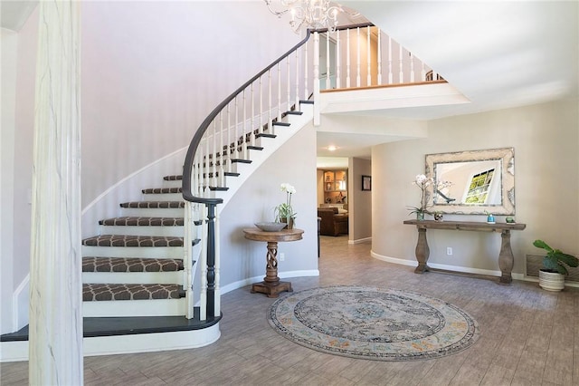 2934 Remy, Burbank, CA 91504 - stairway with baseboards, wood finished floors, a chandelier, and a high ceiling