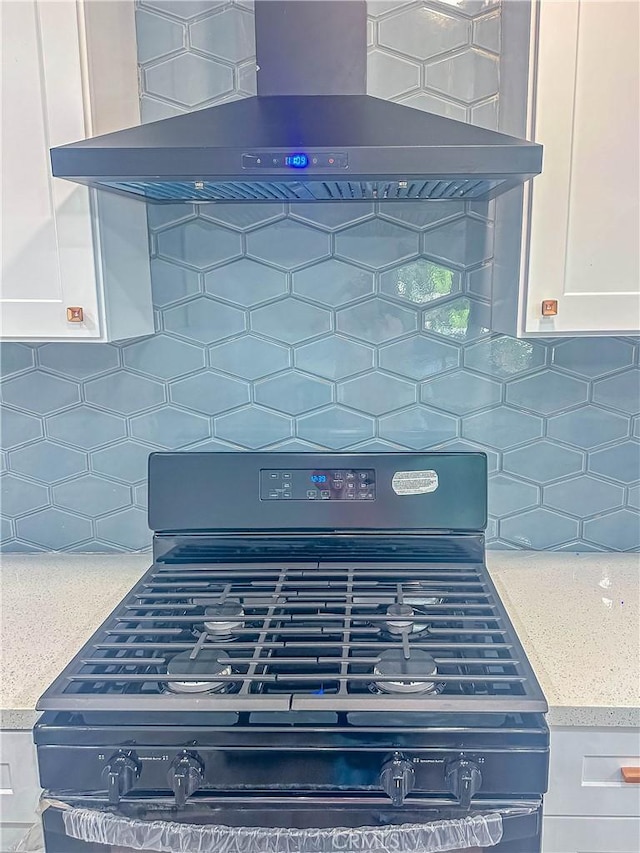 6275 Archibald Ave, Rancho Cucamonga, CA 91737 - kitchen view of wall chimney exhaust hood, black gas range oven, white cabinets, and decorative backsplash